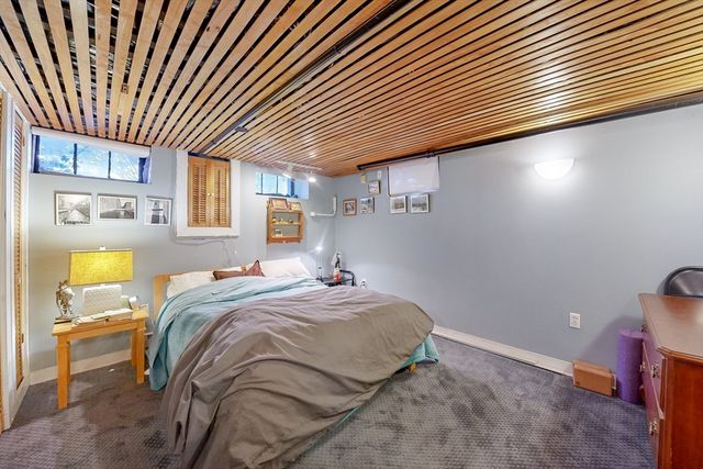 a bed sitting in a bedroom next to a window