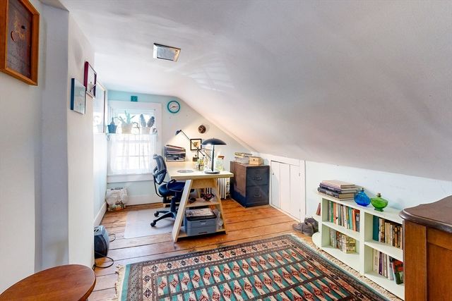 a living room with furniture and a book shelf