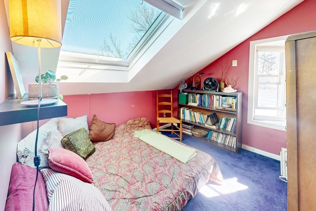 a bedroom with furniture and a book shelf