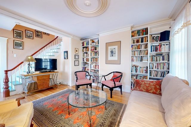 a living room with fireplace furniture and a book shelf
