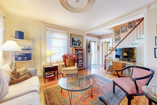 a living room with furniture a couch and a flat screen tv
