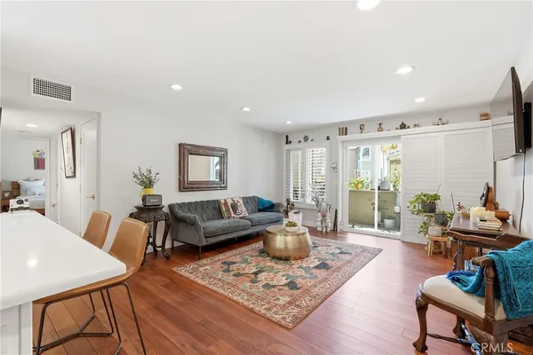 a living room with furniture and wooden floor