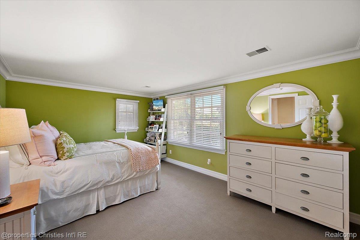 135 Clifton Road Bloomfield Hills, MI 48301 - Photo 45 of 77 Room featuring a neutral carpet, two windows with blinds, and white crown molding