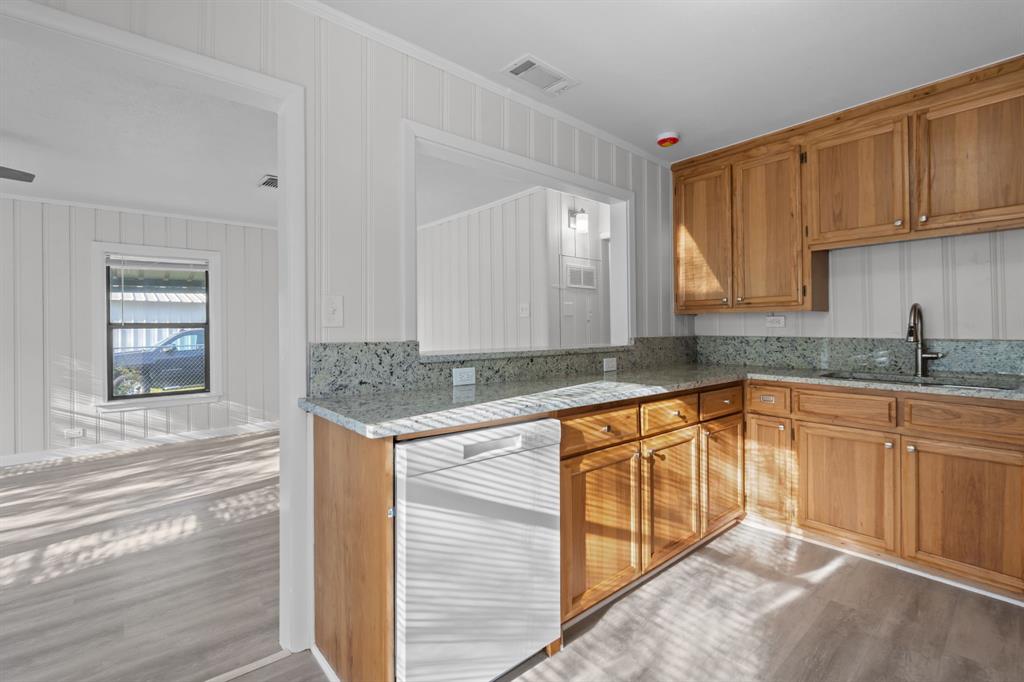 217 Clinton Drive Weatherford, TX 76086 - Photo 6 of 19 a kitchen with granite countertop a sink and cabinets
