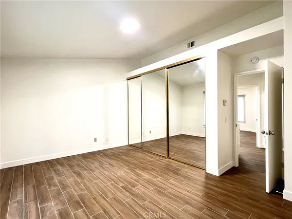 a view of an empty room and wooden floor