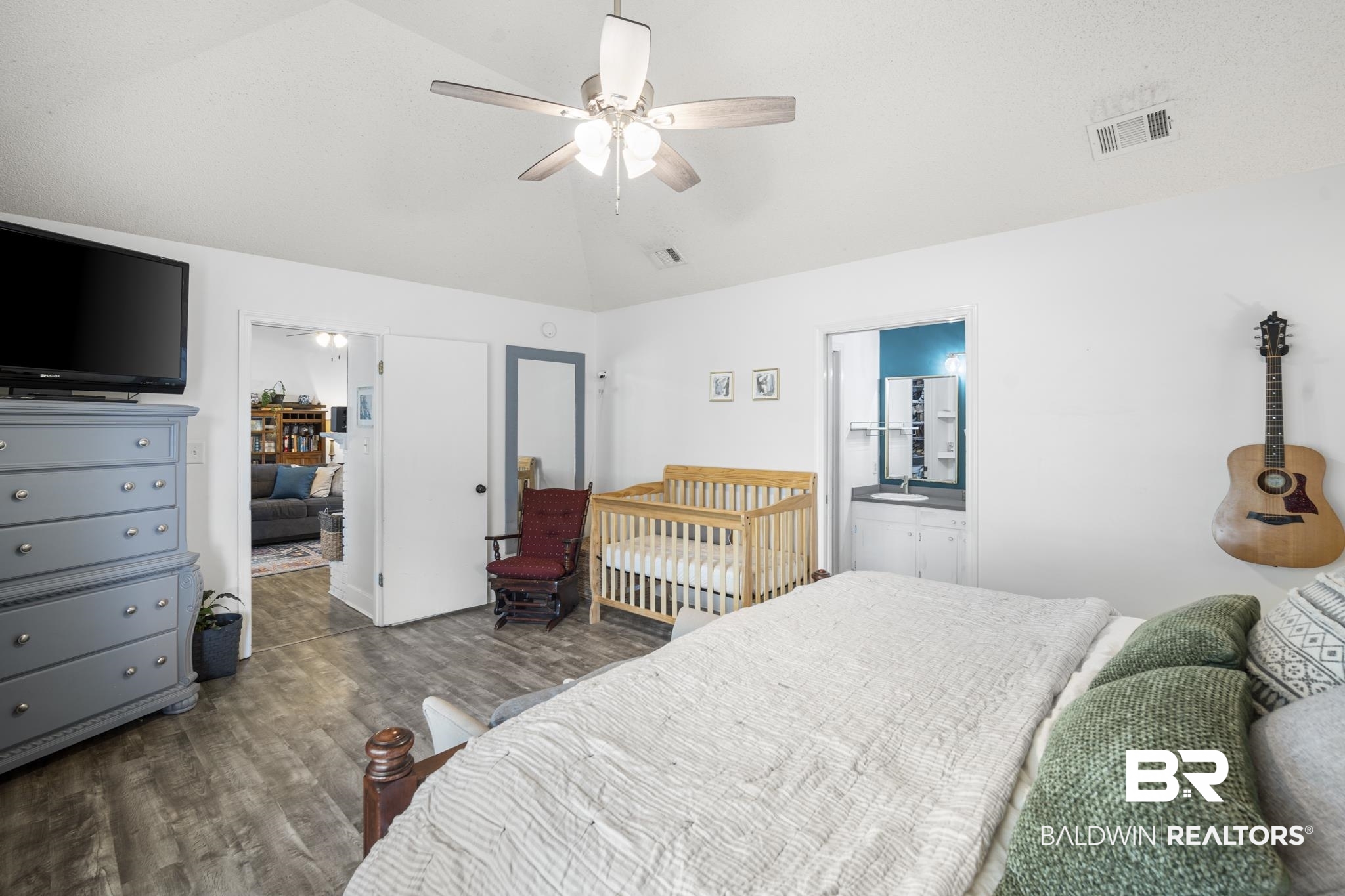 117 Richmond Road Daphne, AL 36526 - Photo 18 of 41 Bedroom with lofted ceiling, wood finished floors, a ceiling fan, and ensuite bath