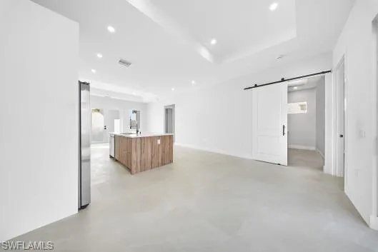 a kitchen with kitchen island a sink stainless steel appliances and cabinets