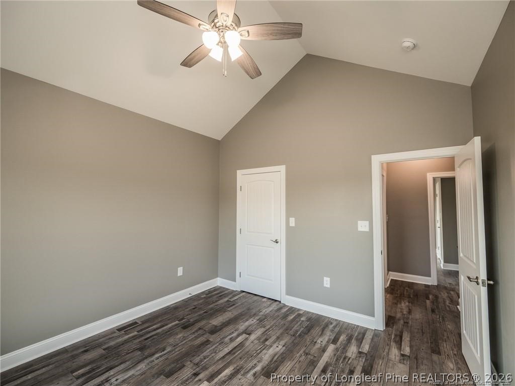 1102 West Carthage Road Lumberton, NC 28360 - Photo 28 of 41 an empty room with wooden floor closet and fan