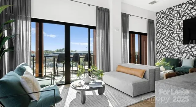 a living room with fireplace furniture and a large window
