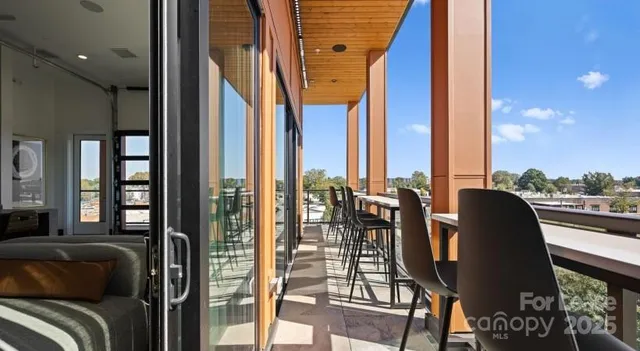 a view of a living room and a balcony