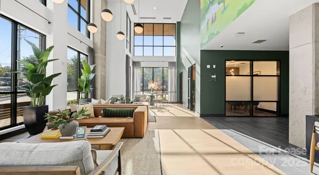 a lobby with furniture and floor to ceiling window