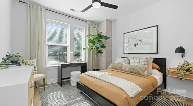 a bedroom with a bed and a potted plant