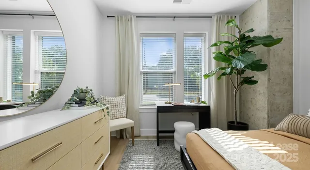 a bath room with a bed potted plant and a window