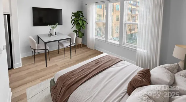 a bedroom with a bed potted plant with the mirror