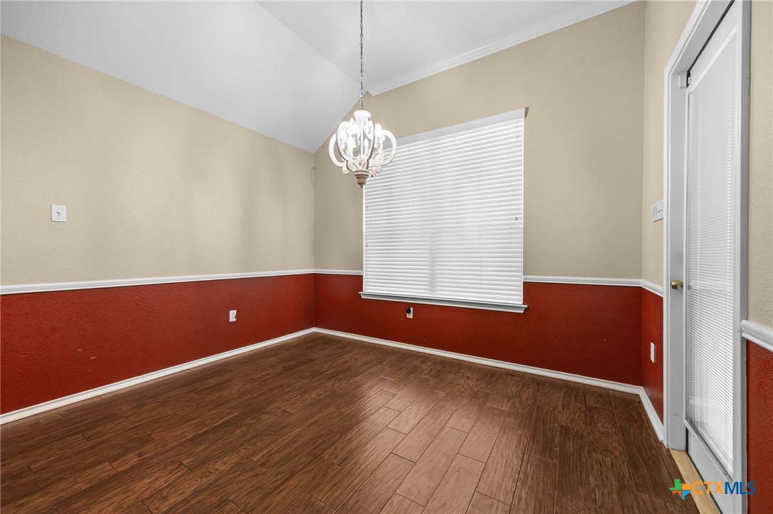 910 Neuberry Cliffe Temple, TX 76502 - Photo 13 of 32 a view of room with wooden floor and chandelier
