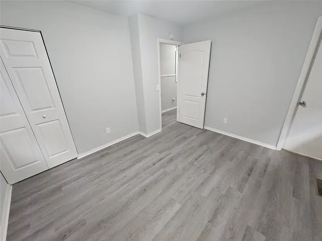 an empty room with wooden floor