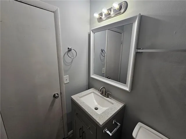 a bathroom with a sink a mirror and vanity