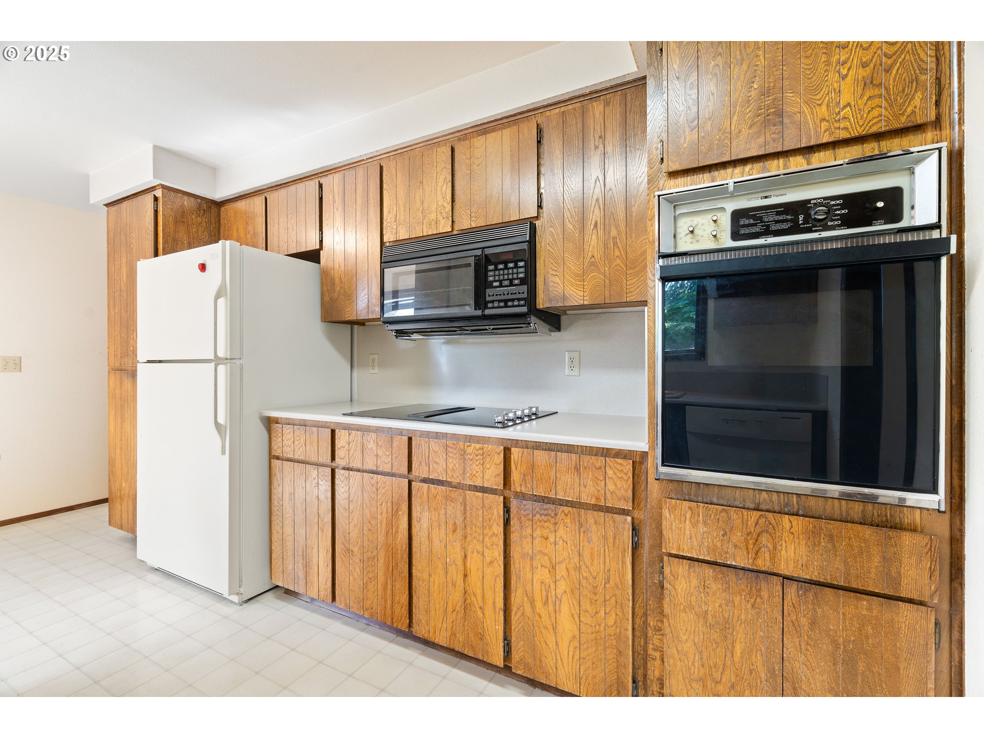 1246 Southeast Barnes Road Gresham, OR 97080 - Photo 14 of 43 a kitchen with stainless steel appliances a stove a microwave and a refrigerator
