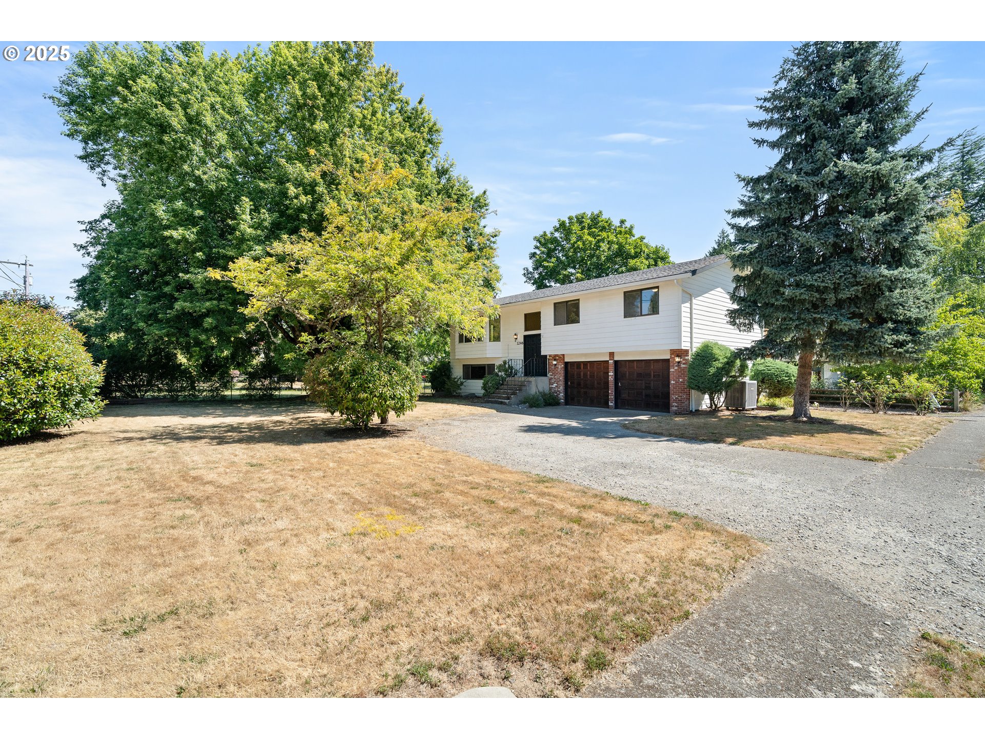 1246 Southeast Barnes Road Gresham, OR 97080 - Photo 2 of 43 a view of a white house with a yard and large trees