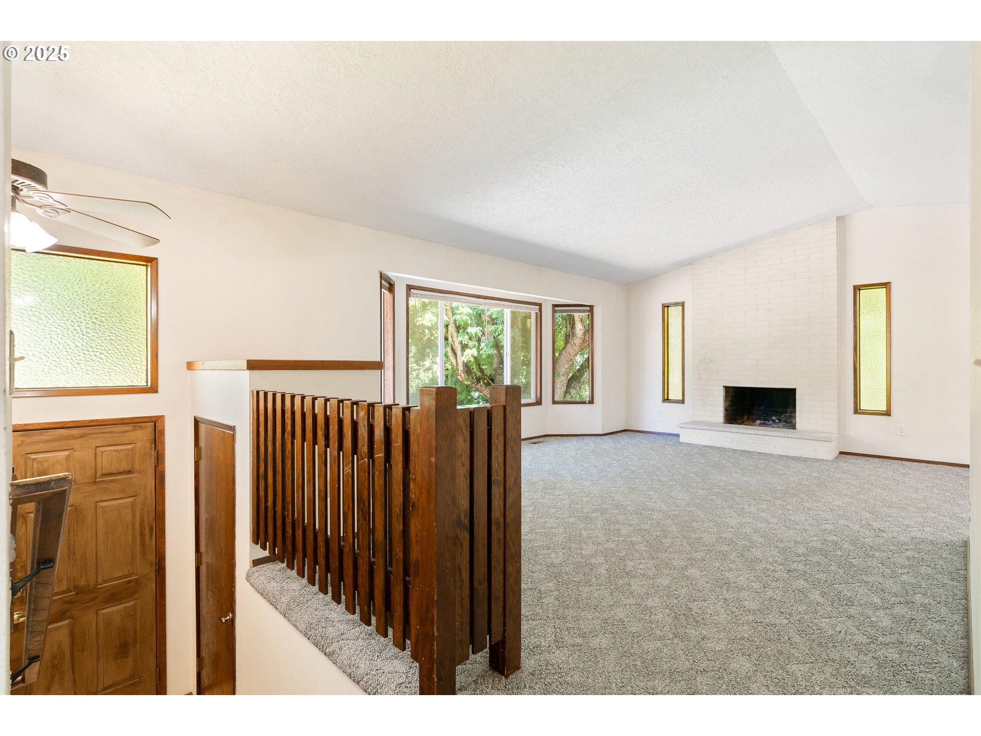 1246 Southeast Barnes Road Gresham, OR 97080 - Photo 4 of 43 a view of empty room with fireplace and windows