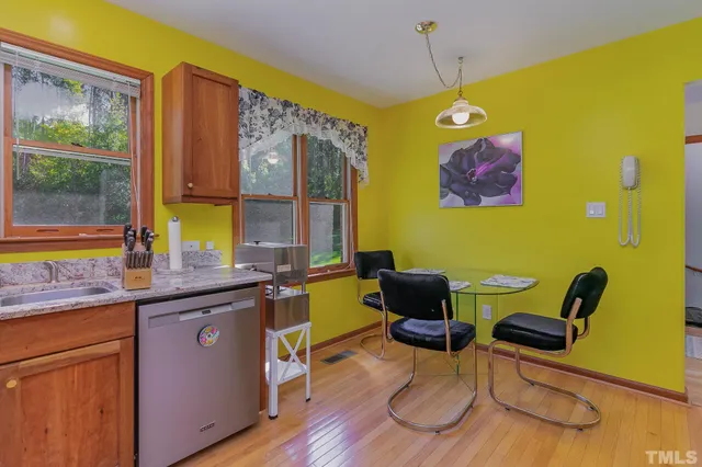 a view of a kitchen with a window and chairs