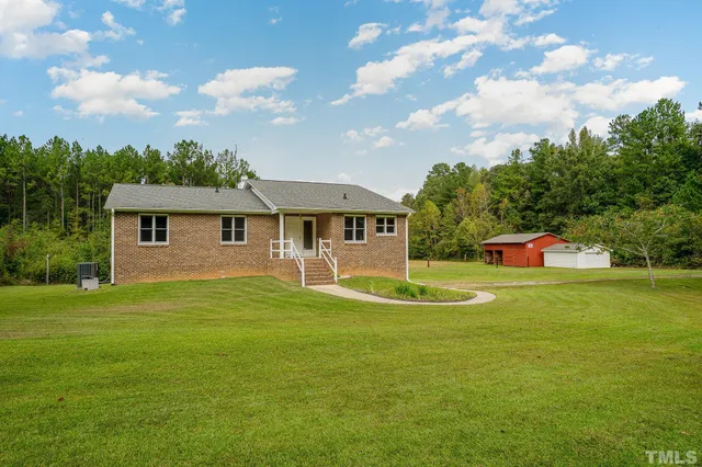 a front view of house with yard and trees