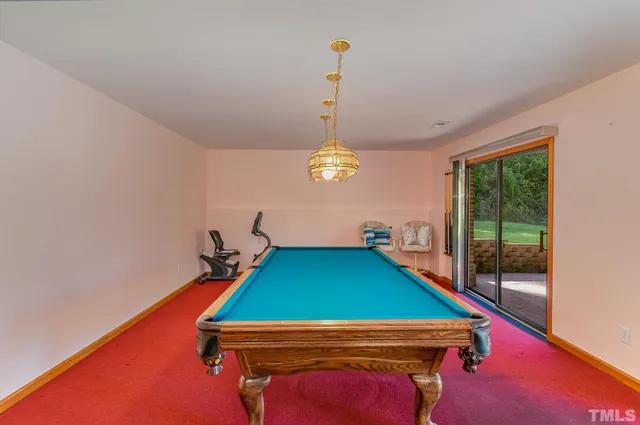 a room with pool tables and windows