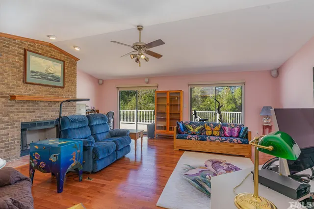 a living room with furniture fireplace and a large window