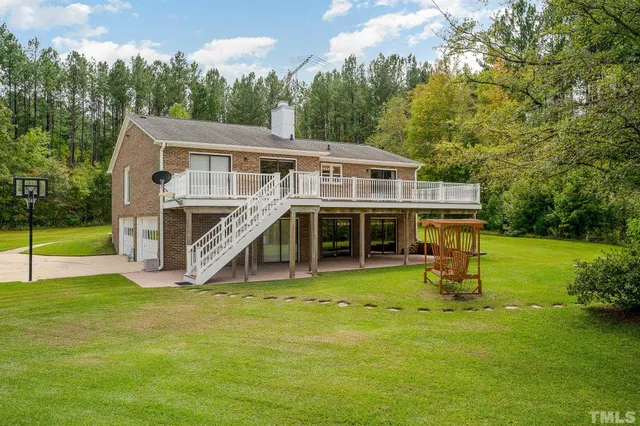 a view of a house with a yard and sitting area