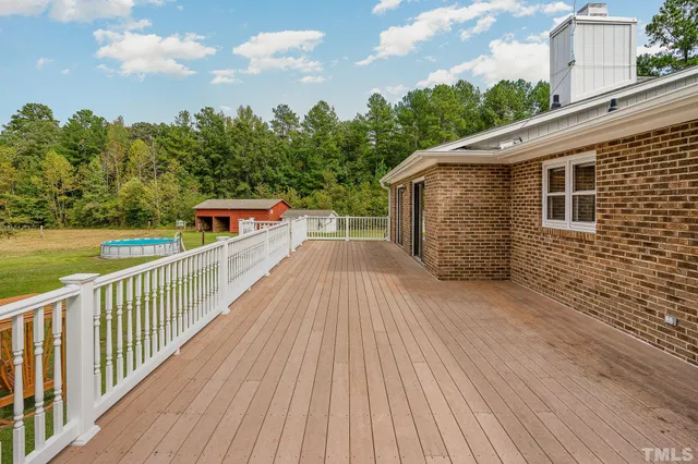 a view of a balcony with wooden floor and fence
