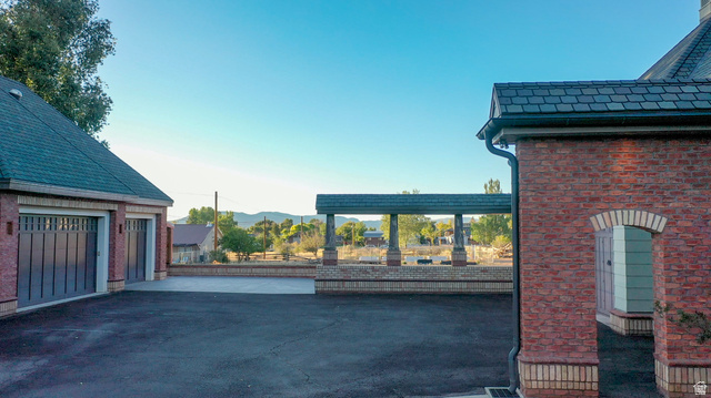 426 West Center Street Parowan, UT 84761 - Photo 89 of 107 Expansive paved driveway leading to a two-car garage with dark paneled doors