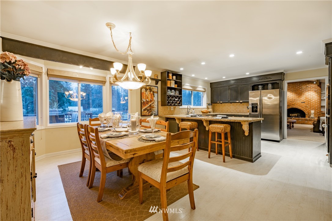 8403 Kickerville Road Blaine, WA 98230 - Photo 11 of 40 a view of a dining room with furniture and a chandelier