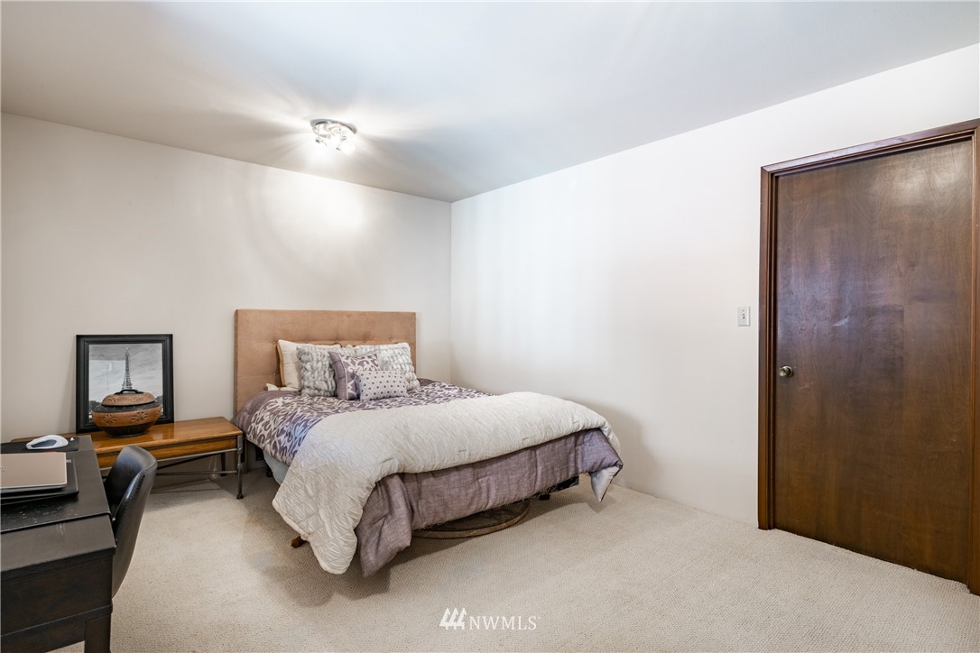 8403 Kickerville Road Blaine, WA 98230 - Photo 22 of 40 a bedroom with a bed and a lamp on table