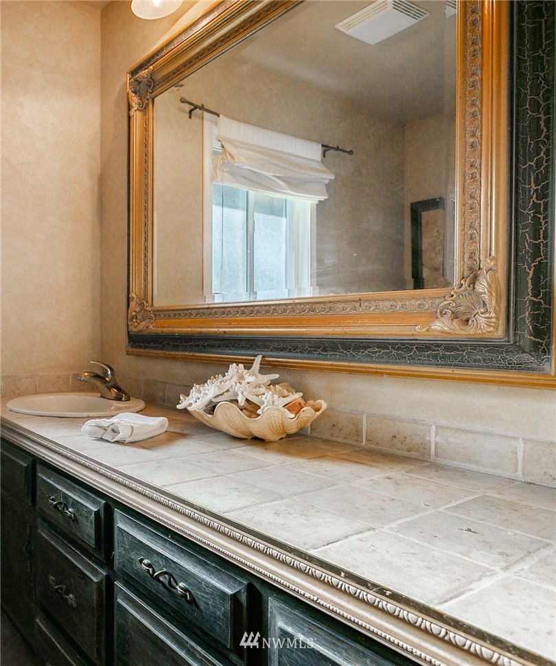 8403 Kickerville Road Blaine, WA 98230 - Photo 24 of 40 a bathroom with a sink and a mirror