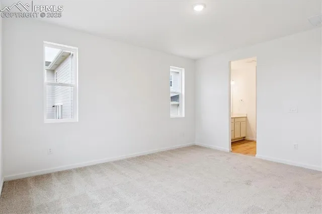 an empty room with windows and closet