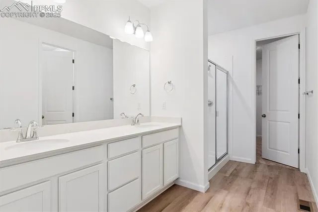 a bathroom with a double vanity sink and mirror