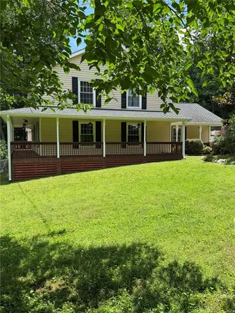 a view of a house with a backyard