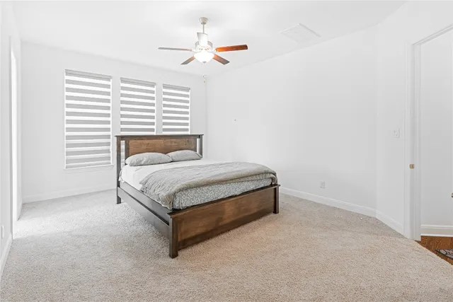 a bathroom with a granite countertop sink a mirror and a bathtub