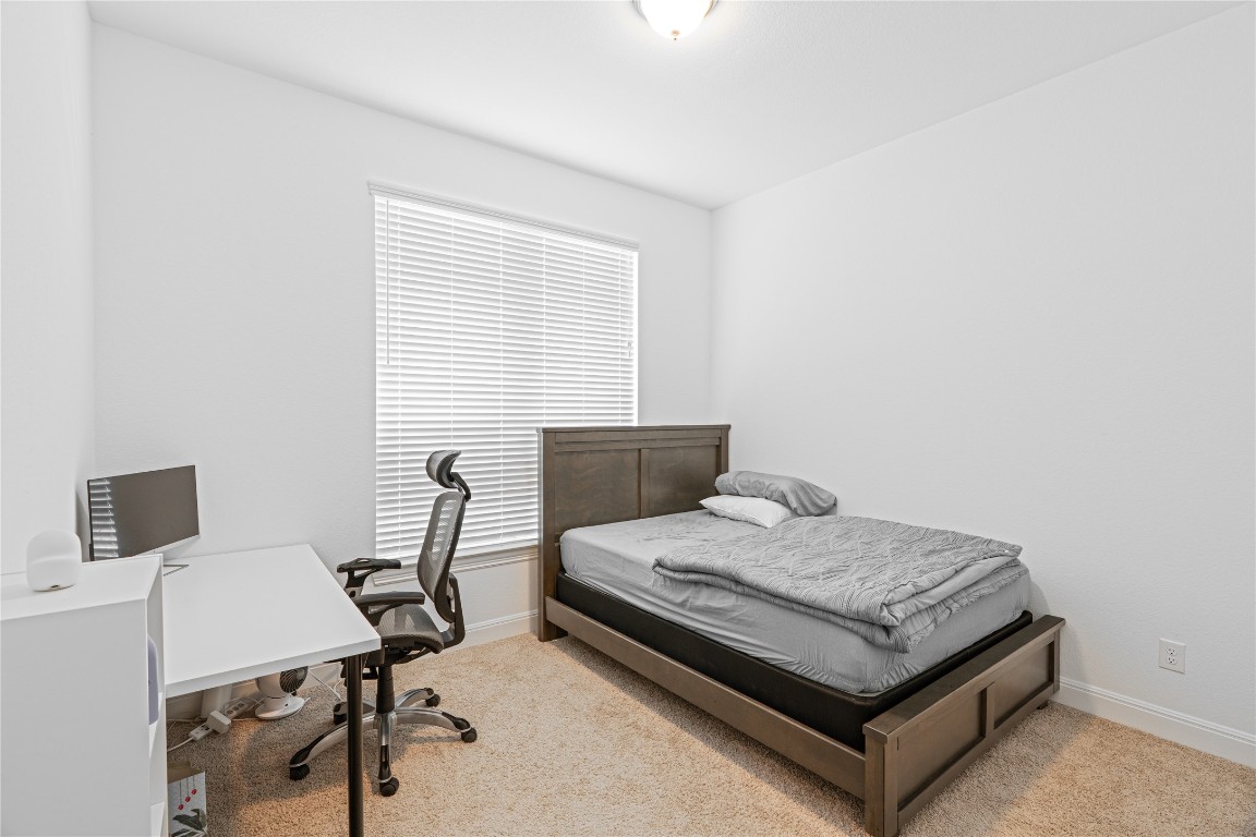 3037 Sage Ranch Drive Leander, TX 78641 - Photo 19 of 26 a bedroom with a bed and a desk