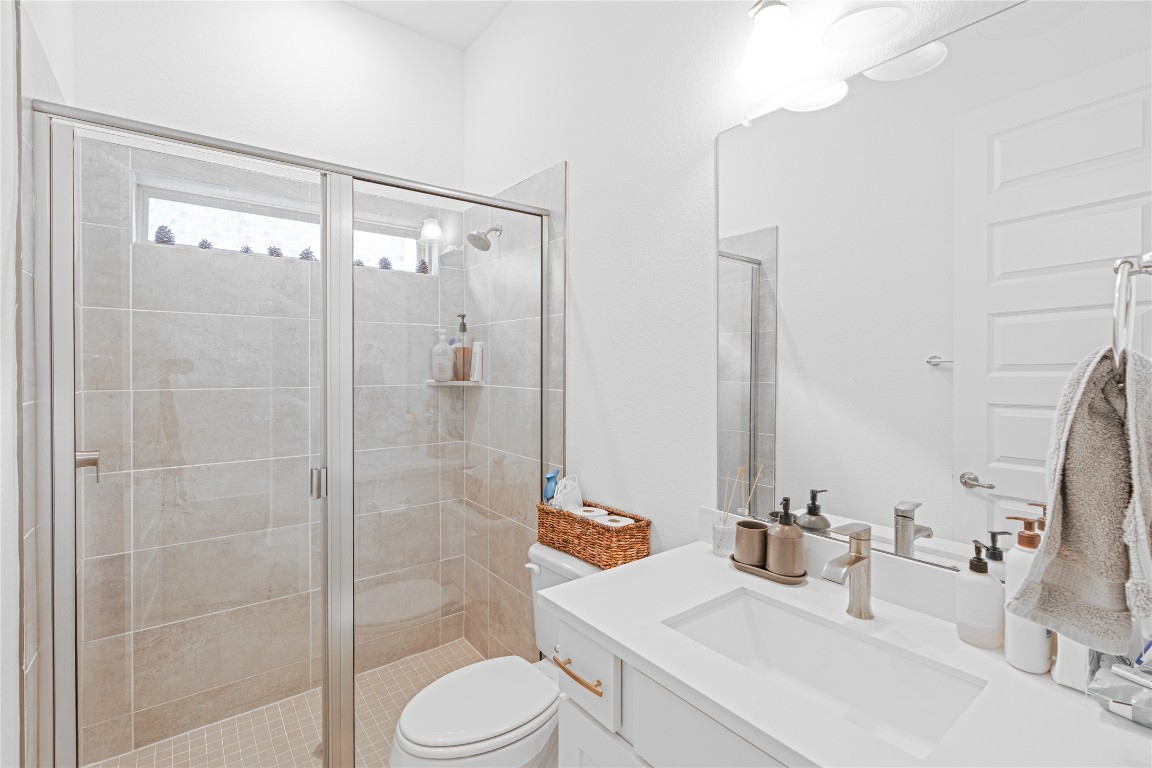 3037 Sage Ranch Drive Leander, TX 78641 - Photo 20 of 26 a bathroom with a sink a toilet and shower