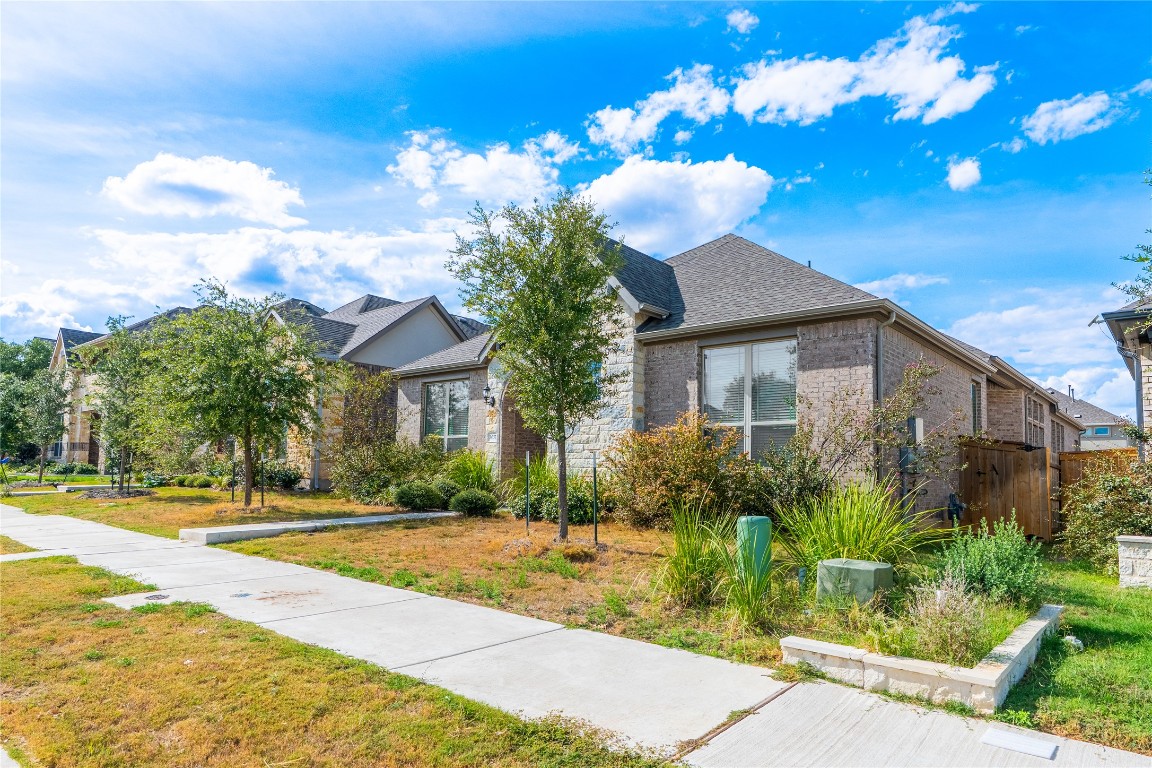 3037 Sage Ranch Drive Leander, TX 78641 - Photo 2 of 26 a view of a house with a yard and potted plants