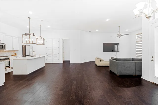 a living room with fireplace furniture and a wooden floor
