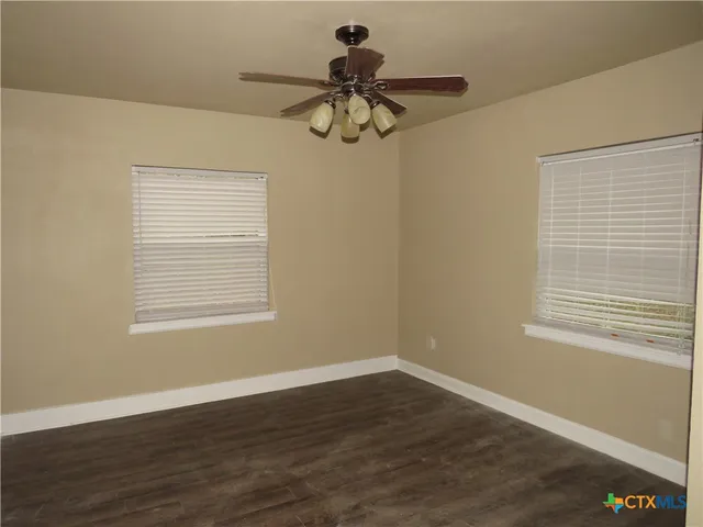 a glass door with a chandelier fan and windows