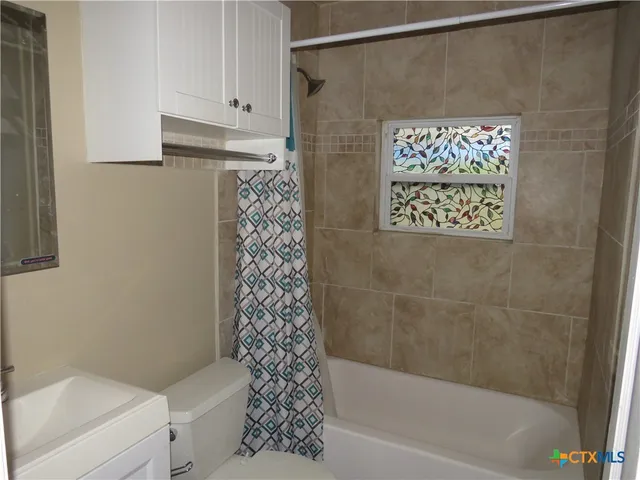 a bathroom with a shower and a toilet
