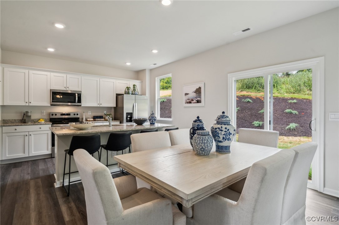 237 Central Parkway Aylett, VA 23009 - Photo 11 of 24 a kitchen with a table chairs microwave and cabinets