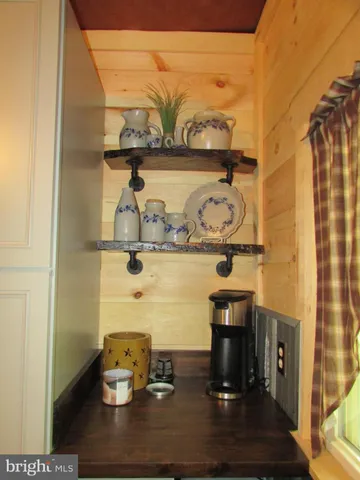 a kitchen with granite countertop a sink a stove and cabinets