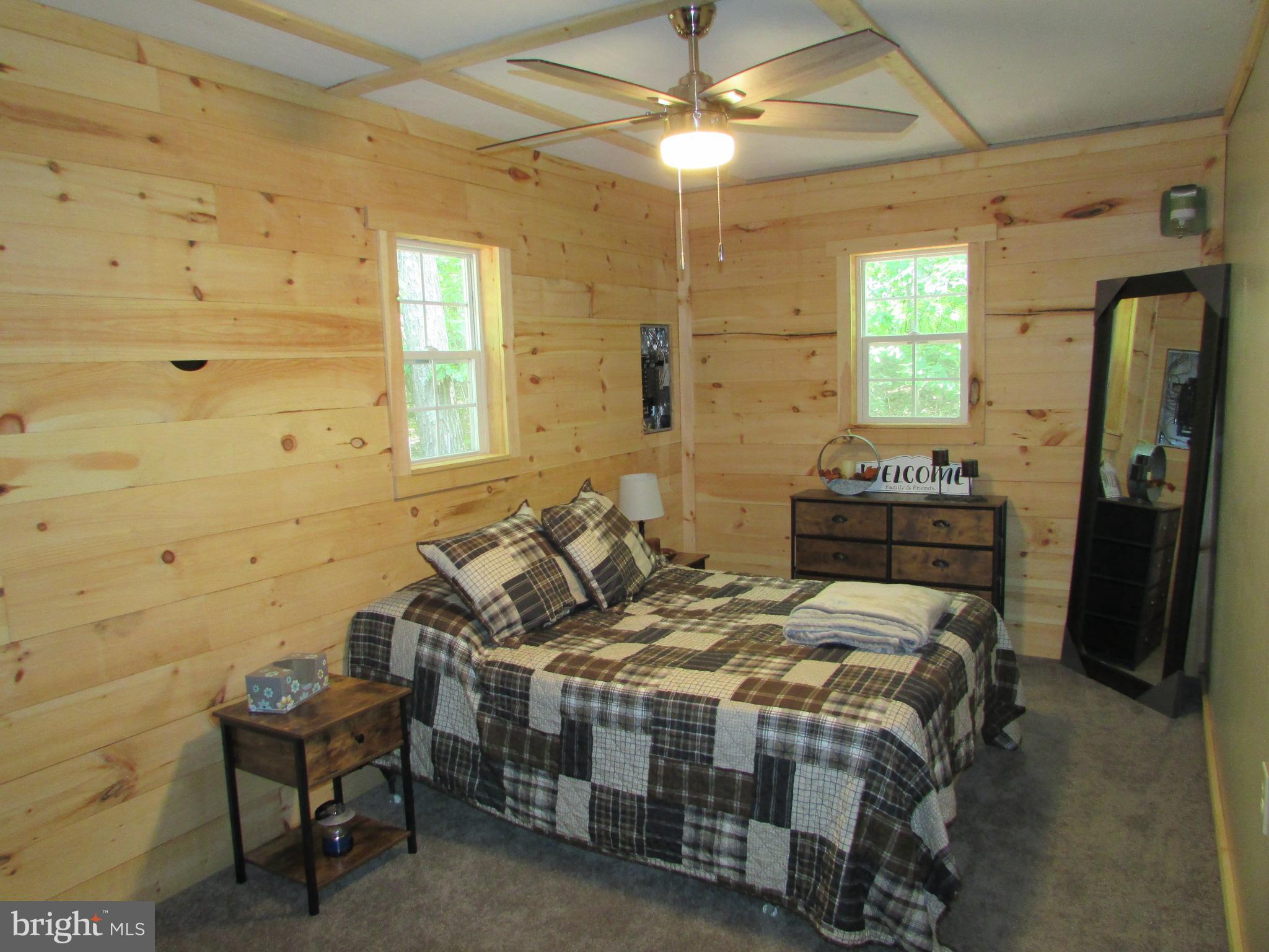 293 Snow Shoe Mountain Forest Road Snow Shoe, PA 16874 - Photo 16 of 38 a bedroom with a bed and a chandelier