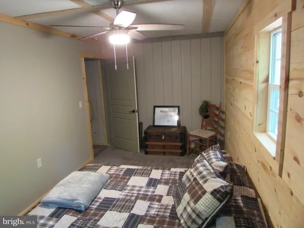 a bed sitting in a room next to a window