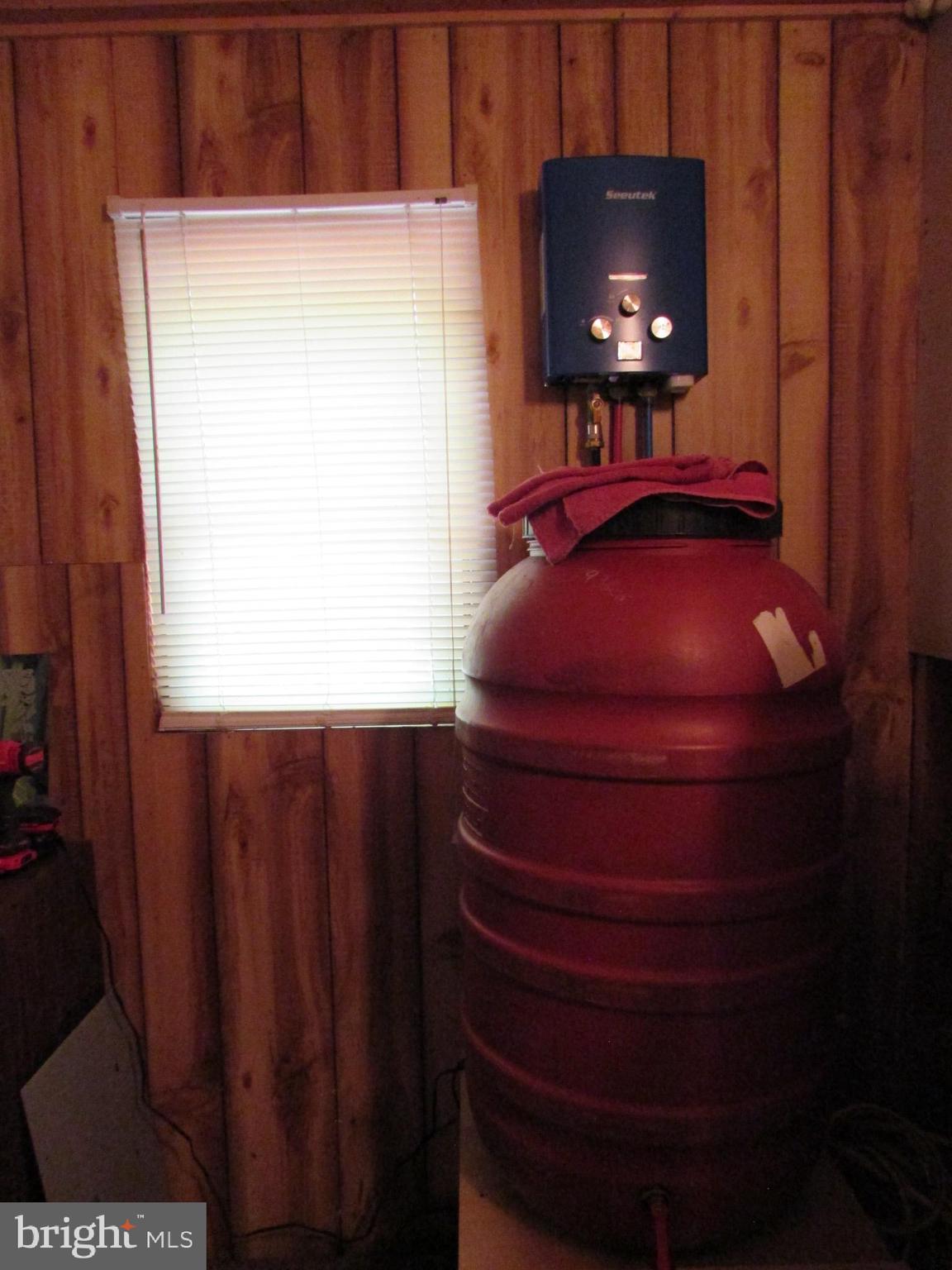 293 Snow Shoe Mountain Forest Road Snow Shoe, PA 16874 - Photo 20 of 38 a room with a chair and a flat screen tv