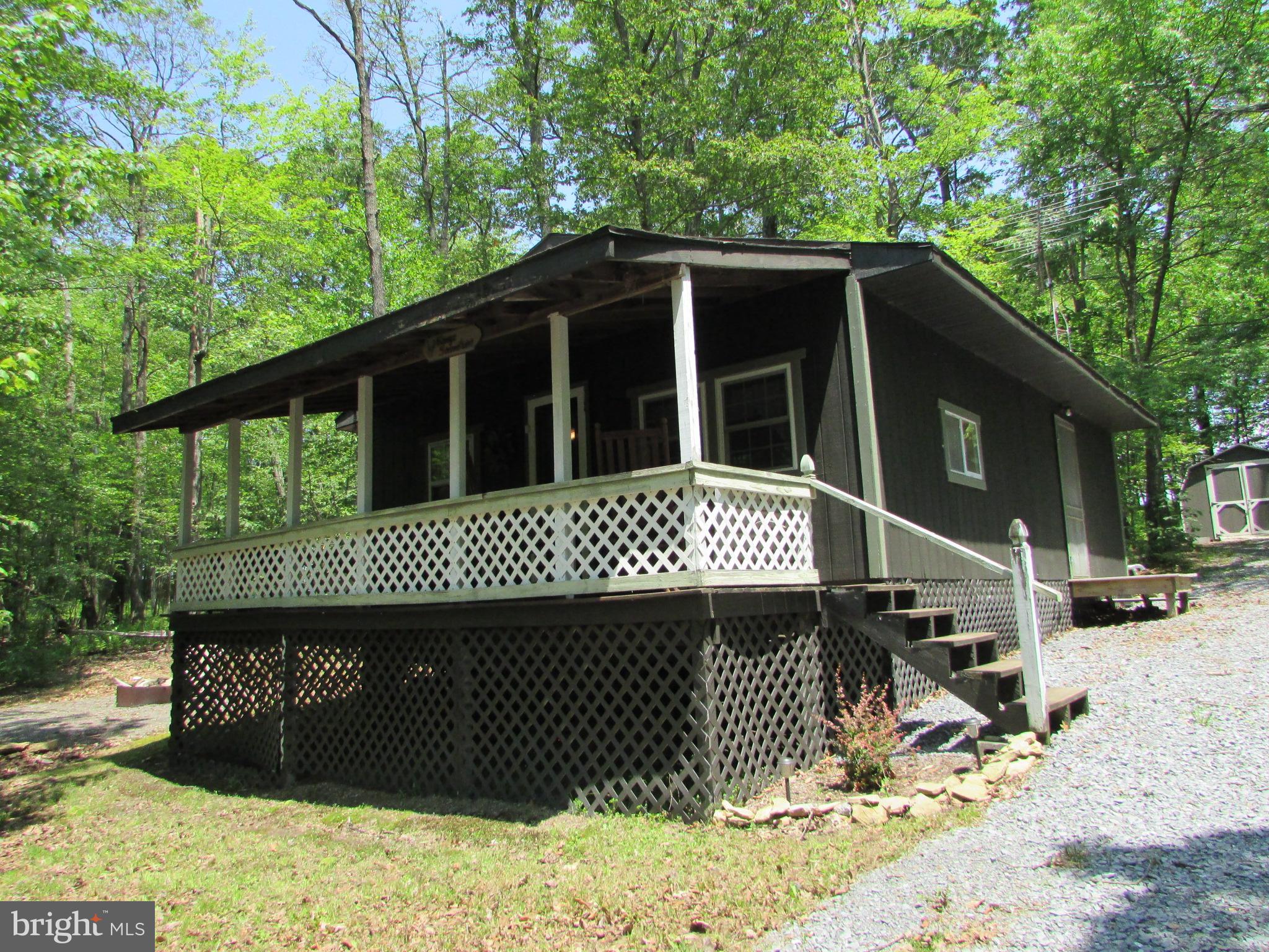 293 Snow Shoe Mountain Forest Road Snow Shoe, PA 16874 - Photo 2 of 38 a front view of a house with a garden